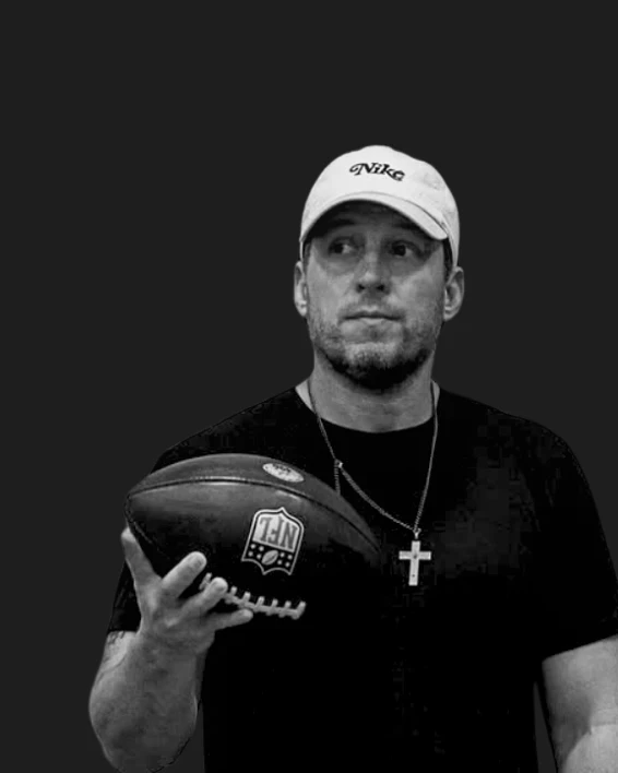 Portrait of Denny Thompson holding a football