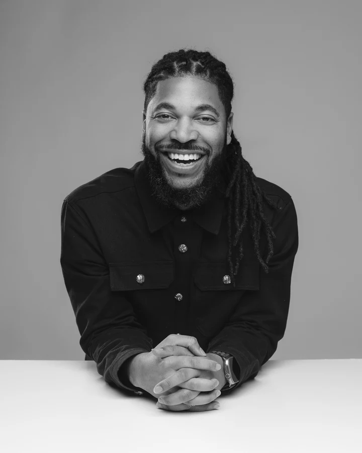 Tim Timberlake smiling in a seated portrait