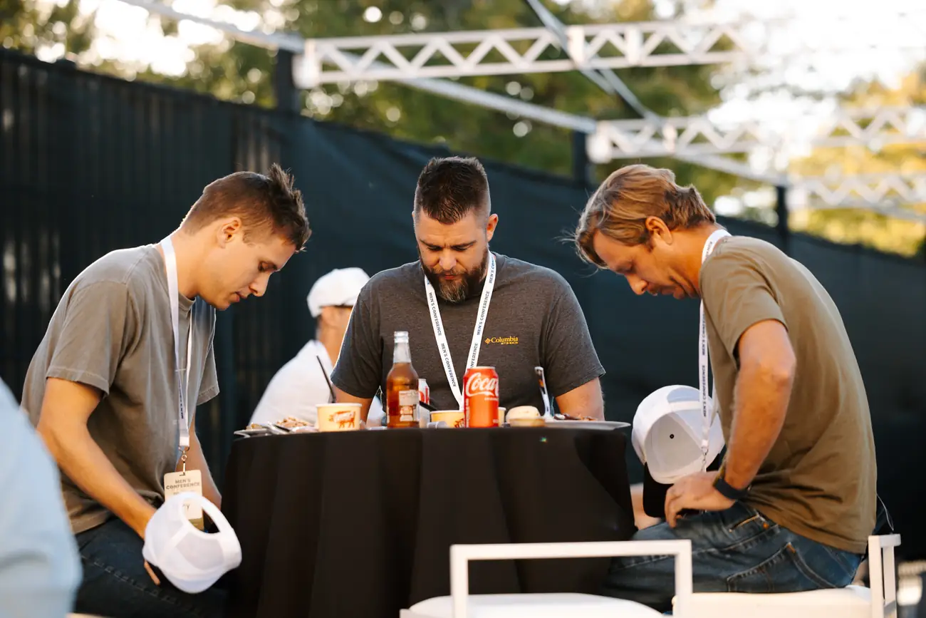 Men eating together at a table during the conference